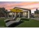 Cozy outdoor seating area with lush artificial turf, perfect for relaxation and enjoying the sunset at 10224 S 175Th Ave, Goodyear, AZ 85338