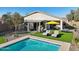 Relaxing backyard with pool, artificial turf, and ample seating, ideal for outdoor enjoyment at 10224 S 175Th Ave, Goodyear, AZ 85338