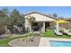 Backyard with a pool, patio, outdoor seating and a large tree at 10224 S 175Th Ave, Goodyear, AZ 85338