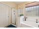 Bathroom featuring a shower and a bathtub, as well as a window with privacy glass at 10224 S 175Th Ave, Goodyear, AZ 85338