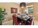 Elegant dining room showcasing a marble table, stylish chairs, and view of the sparkling pool outside at 10224 S 175Th Ave, Goodyear, AZ 85338
