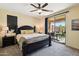 Bedroom features a ceiling fan and a door opening to the backyard at 10224 S 175Th Ave, Goodyear, AZ 85338