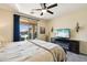 Bedroom featuring a ceiling fan and a door opening to the backyard with a pool at 10224 S 175Th Ave, Goodyear, AZ 85338