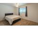 Simple bedroom with a comfortable bed, ceiling fan, and natural light, offering a blank canvas at 10713 E Oasis Dr, Mesa, AZ 85208