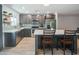 Modern kitchen features stainless steel appliances, a center island with seating, and stylish countertops at 10713 E Oasis Dr, Mesa, AZ 85208