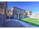 Backyard featuring artificial grass, brick pavers, patio and block wall fencing at 10817 W Pierson St, Phoenix, AZ 85037