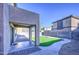 Backyard featuring artificial grass, brick pavers, patio and block wall fencing at 10817 W Pierson St, Phoenix, AZ 85037