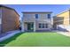 Backyard featuring artificial grass, brick pavers, patio and block wall fencing at 10817 W Pierson St, Phoenix, AZ 85037