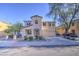 Charming two-story home with desert landscaping, mature trees, and a welcoming entrance at 10817 W Pierson St, Phoenix, AZ 85037