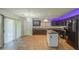 Spacious kitchen with dark cabinets, granite countertops, and stainless steel appliances at 10817 W Pierson St, Phoenix, AZ 85037