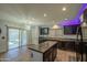 Bright kitchen with island, modern appliances, and access to the outdoor space at 10817 W Pierson St, Phoenix, AZ 85037