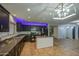 Modern kitchen featuring dark cabinetry, stainless steel appliances, and an island at 10817 W Pierson St, Phoenix, AZ 85037