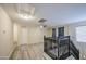 Upstairs living room featuring wood floors, a ceiling fan and a staircase at 10817 W Pierson St, Phoenix, AZ 85037