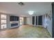 Elegant living room with tiled floors, built-in shelving, and custom fireplace at 10817 W Pierson St, Phoenix, AZ 85037