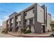 Exterior view of a multi-unit apartment building featuring gray accents and access stairs at 1215 E Lemon St # 222, Tempe, AZ 85281