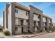 Exterior view of apartment building featuring multiple units, stairs, gray accents, and a red tile roof at 1215 E Lemon St # 222, Tempe, AZ 85281