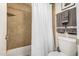 Bathroom featuring shower over tub, neutral tile, and soft towels at 1215 E Lemon St # 222, Tempe, AZ 85281