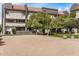 Apartment complex exterior featuring a beach volleyball court and mature trees at 1215 E Lemon St # 222, Tempe, AZ 85281