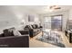 Comfortable living room with neutral furniture, ceiling fan, and a sliding glass door to a patio at 1215 E Lemon St # 222, Tempe, AZ 85281