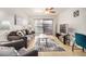 Comfortable living room with neutral furniture, ceiling fan, and a sliding glass door to a patio at 1215 E Lemon St # 222, Tempe, AZ 85281