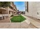 Scenic walkway between unit buildings with verdant landscaping leading to community amenities at 1215 E Lemon St # 222, Tempe, AZ 85281