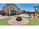 Large backyard with a pool, fire pit and outdoor living area with comfortable seating and a covered patio at 1266 S Harrington St, Gilbert, AZ 85233