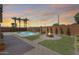 Picturesque backyard featuring a pool, fire pit, manicured lawn, and palm trees for a resort-like experience at 1266 S Harrington St, Gilbert, AZ 85233