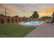 Lush backyard with a sparkling pool, brick patio, and vibrant landscaping, ideal for relaxation and outdoor gatherings at 1266 S Harrington St, Gilbert, AZ 85233