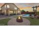 Resort-style backyard featuring a pool, fire pit, patio, and lush landscaping at 1266 S Harrington St, Gilbert, AZ 85233