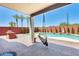 Relaxing backyard with pool, patio and lounge swing set against a brick wall at 1266 S Harrington St, Gilbert, AZ 85233