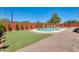 Landscaped backyard featuring a refreshing pool, lush artificial turf, and a paver patio, perfect for outdoor enjoyment at 1266 S Harrington St, Gilbert, AZ 85233