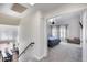 A view of the carpeted bedroom featuring vaulted ceilings, ceiling fan, and large windows with bright, natural light at 1266 S Harrington St, Gilbert, AZ 85233