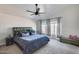 Bedroom featuring a gray upholstered bed, soft carpeting, a ceiling fan, and windows for natural light at 1266 S Harrington St, Gilbert, AZ 85233