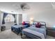 Shared bedroom with twin beds, cartoon pillows, carpeted floor, and a window with natural light at 1266 S Harrington St, Gilbert, AZ 85233