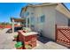 Back of house showing covered patio with outdoor furniture and a grilling station with a built-in grill at 1266 S Harrington St, Gilbert, AZ 85233