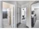 Hallway view showcasing bathroom with a glass-door shower and carpeted bedroom with updated closet organizers at 1266 S Harrington St, Gilbert, AZ 85233