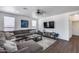 Bright living room showcasing large sectional sofa and media console at 1266 S Harrington St, Gilbert, AZ 85233