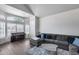 Open-concept living room with large windows, piano, and comfortable sectional sofa at 1266 S Harrington St, Gilbert, AZ 85233