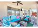 Covered patio with comfortable wicker furniture and mounted television at 1266 S Harrington St, Gilbert, AZ 85233