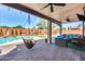Covered patio with cozy seating, ceiling fans, and a view of the pool at 1266 S Harrington St, Gilbert, AZ 85233
