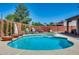 Beautiful backyard featuring a refreshing pool with decorative planters and a seating area for outdoor enjoyment at 1266 S Harrington St, Gilbert, AZ 85233