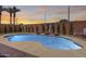 Serene backyard with a pristine pool, mature landscaping, and brick-paved patio, perfect for leisure and recreation at 1266 S Harrington St, Gilbert, AZ 85233