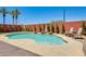 Backyard pool featuring a pebble-stone surround, brick trim and a decorative brick wall with trees at 1266 S Harrington St, Gilbert, AZ 85233