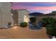 Cozy back patio area with pavers, seating, and a shade umbrella perfect for outdoor relaxation at 12738 W Nogales Dr, Sun City West, AZ 85375