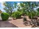 Serene backyard landscape with lush trees and shrubbery, creating a private outdoor retreat at 12738 W Nogales Dr, Sun City West, AZ 85375