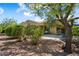 Backyard featuring mature trees and bushes plus a covered patio with outdoor furniture at 12738 W Nogales Dr, Sun City West, AZ 85375
