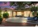 Backyard with a seating area with trees and landscape lighting to set the evening mood at 12738 W Nogales Dr, Sun City West, AZ 85375