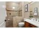 Bathroom featuring a tiled walk-in shower with glass door, seat and coordinated fixtures at 12738 W Nogales Dr, Sun City West, AZ 85375