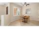 Charming dining area features a round table, shuttered windows, and ceiling fan at 12738 W Nogales Dr, Sun City West, AZ 85375