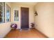 Inviting front porch features decorative door, seasonal floral accents, and a welcoming ambiance at 12738 W Nogales Dr, Sun City West, AZ 85375
